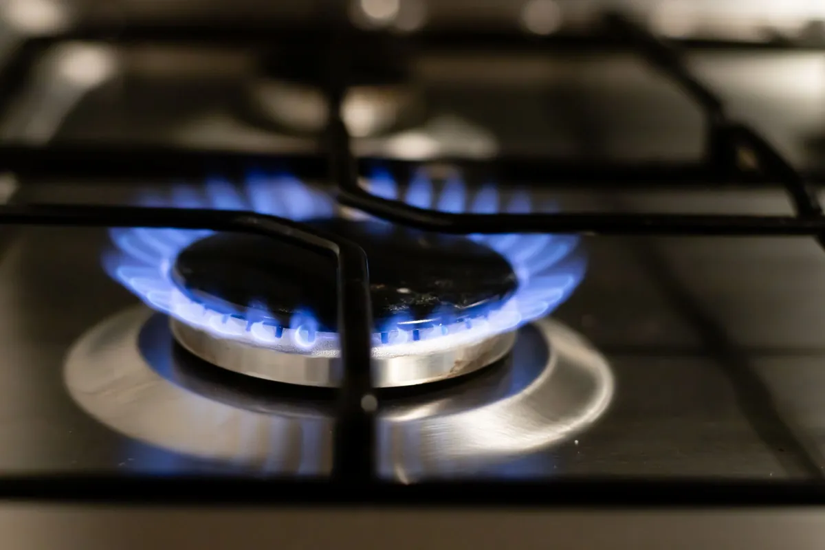 Blue flame burning on a gas hob ring