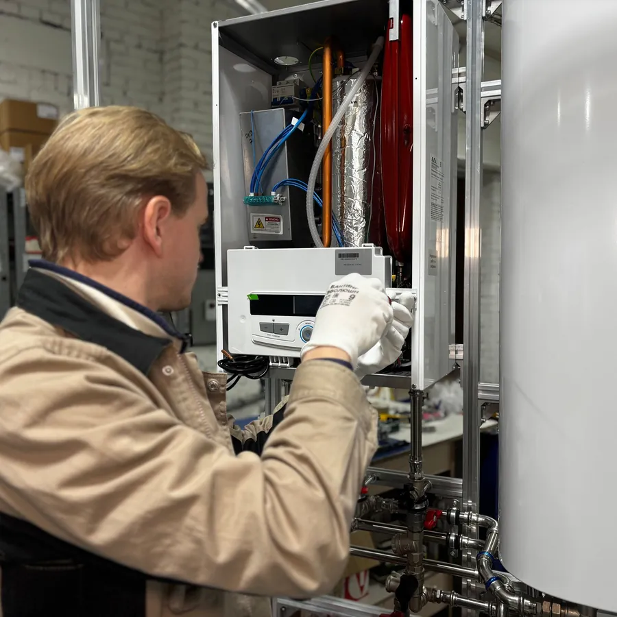 Engineer checking a wall-mounted gas boiler