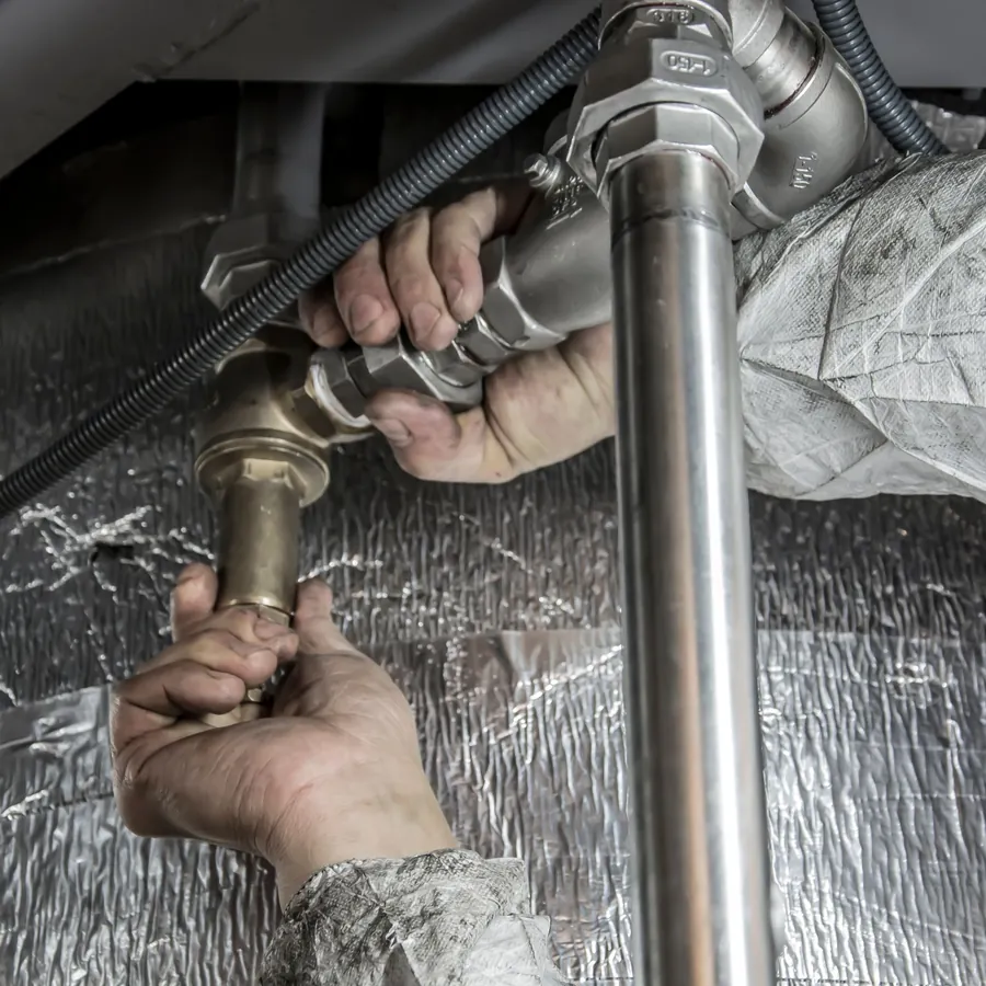 Pipe joint being tightened under a sink