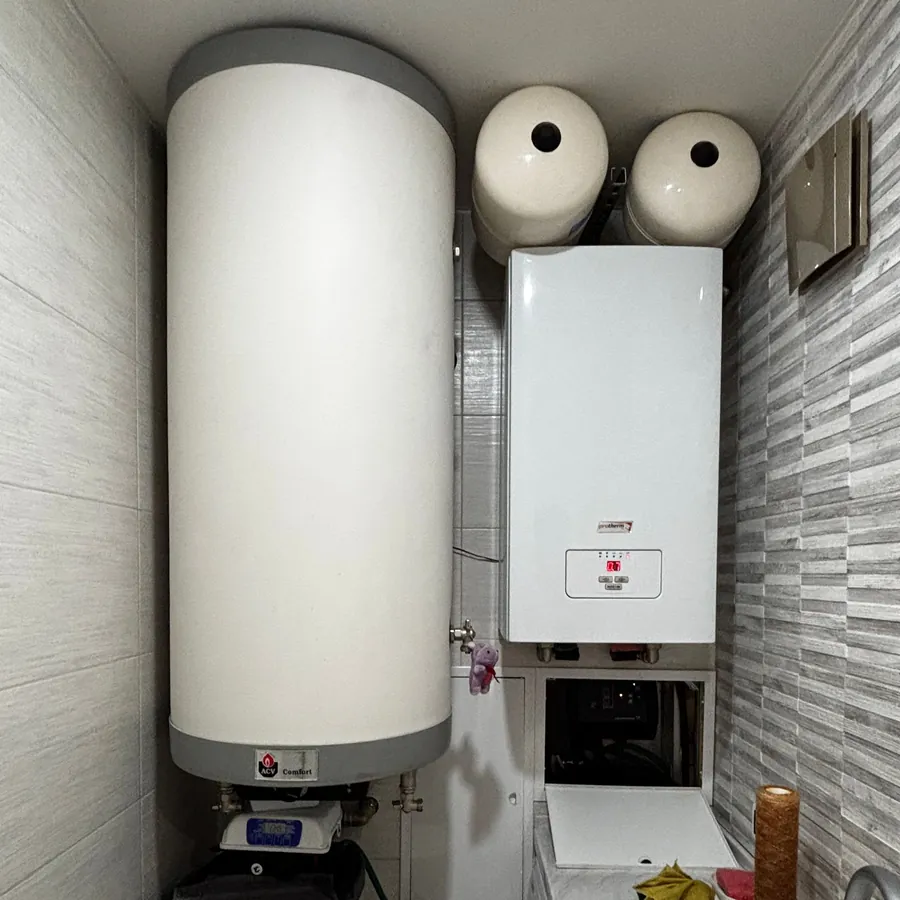New wall boiler beside a hot water cylinder