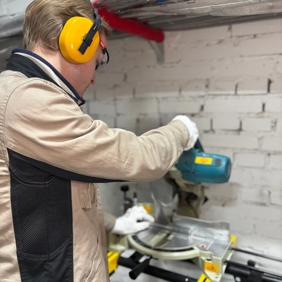 Engineer drilling a wall for a fixing