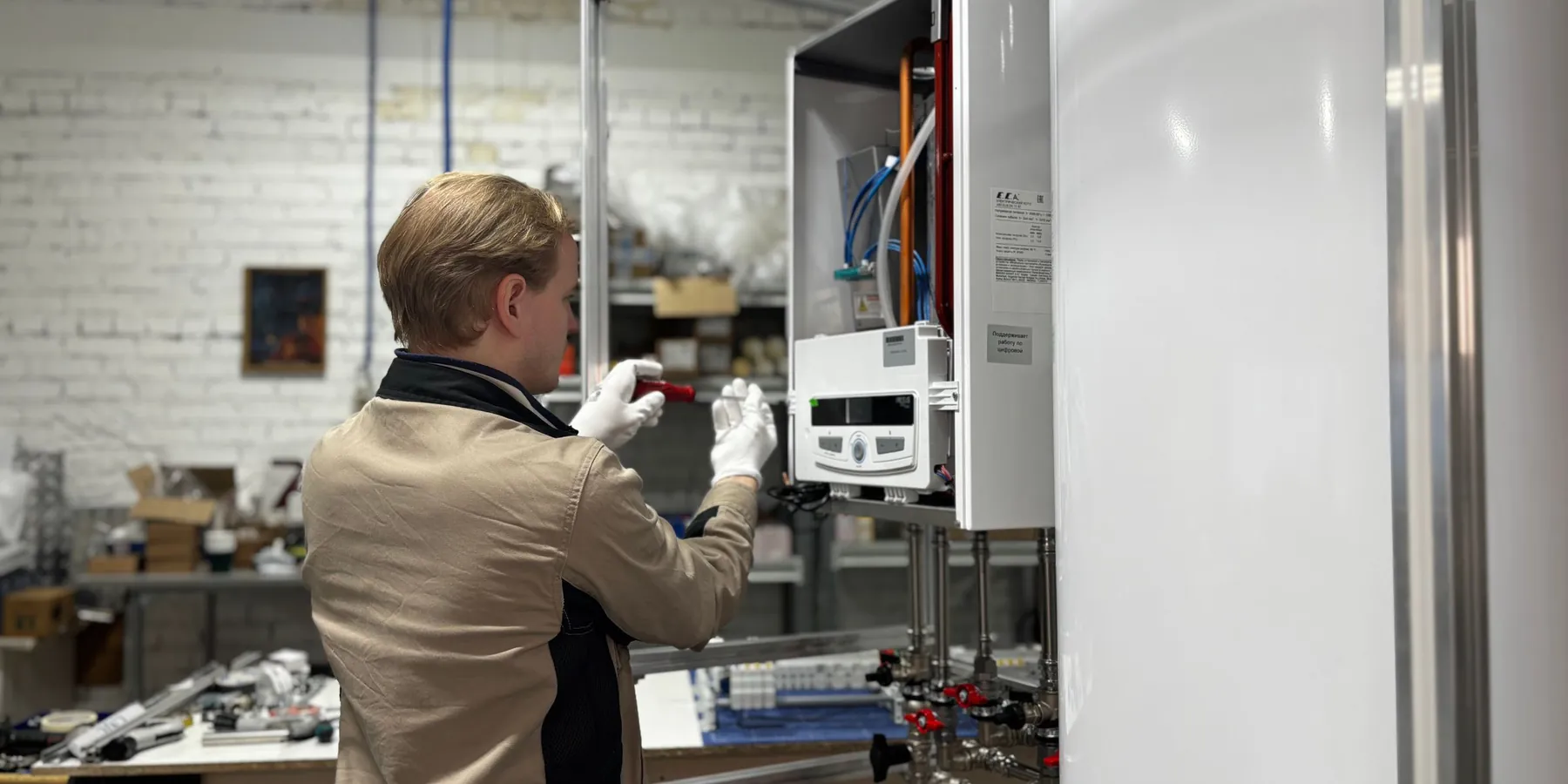 Engineer working on a boiler and its pipework
